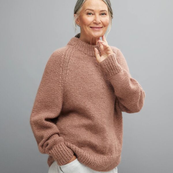 Lady wearing pink knitted high neck jumper