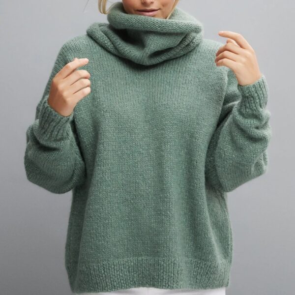 Lady wearing high neck green knitted fluffy jumper